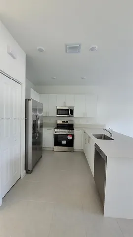 a kitchen with a refrigerator and a stove