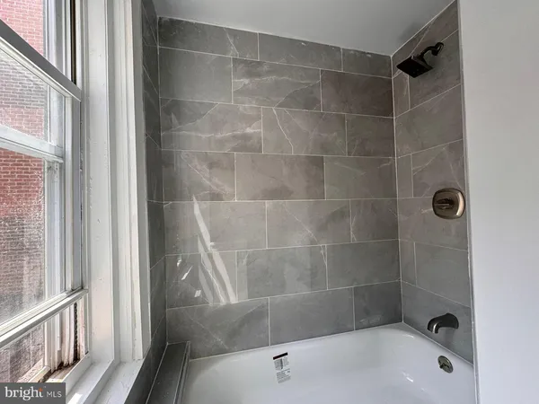 a bathroom with a shower and a bathtub