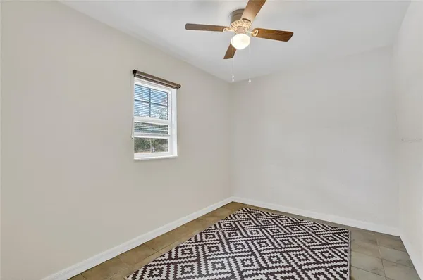 an empty room with a window and closet