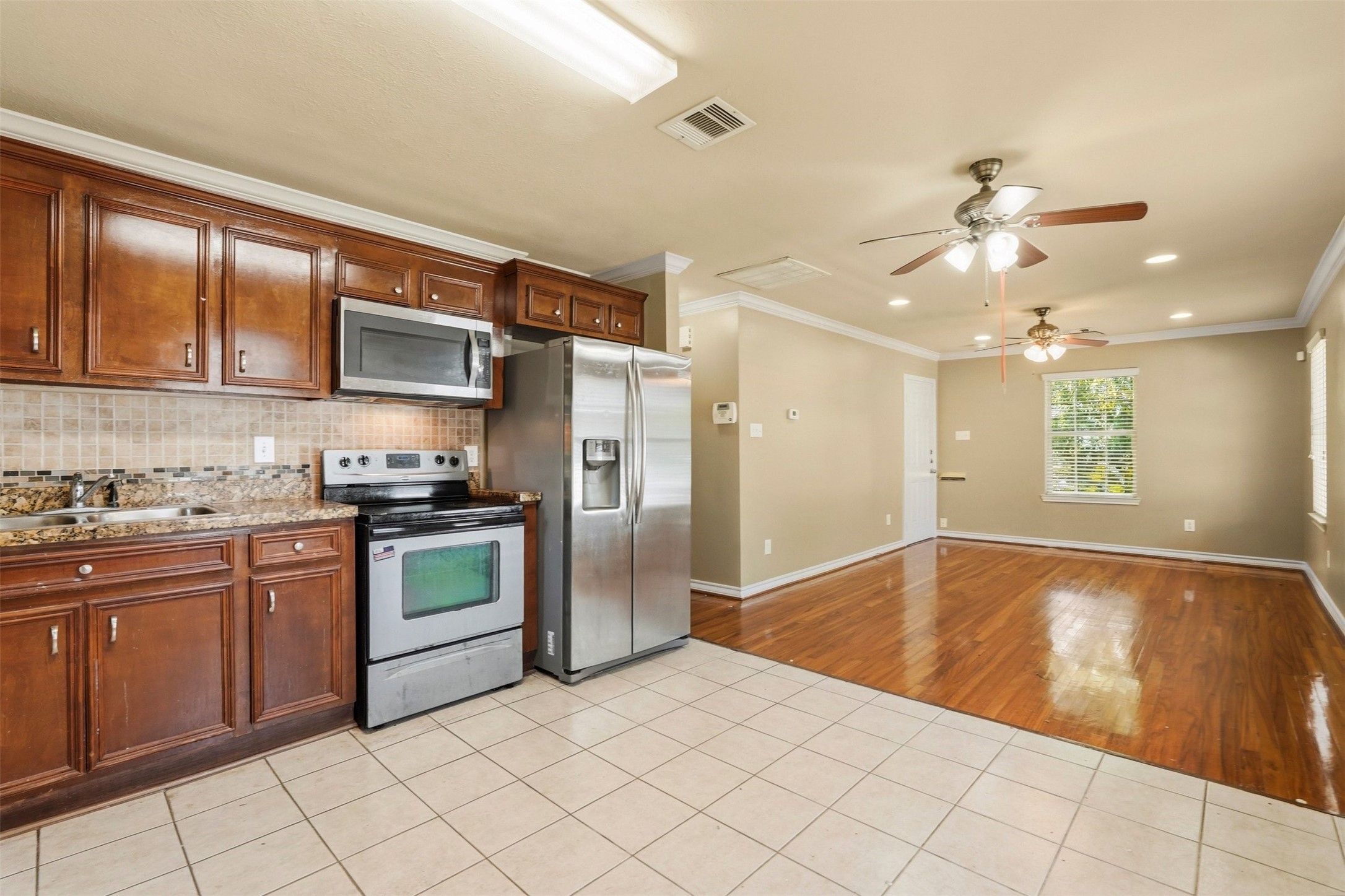 3445 Nathaniel Brown Street Houston, TX 77021 - Photo 11 of 19 a kitchen with stainless steel appliances granite countertop a refrigerator and a sink