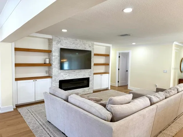 a living room with furniture and a fireplace