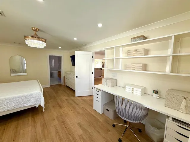 a bedroom with a bed and a chandelier