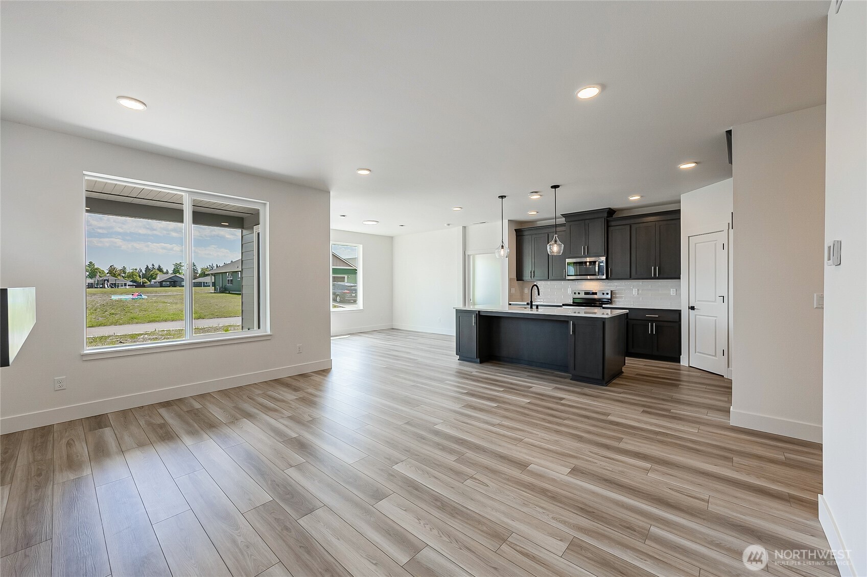 402 Pagget Avenue Winlock, WA 98596 - Photo 12 of 36 a large kitchen with stainless steel appliances a large counter top a wooden floors and a view of kitchen