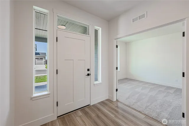 an empty room with windows and closet