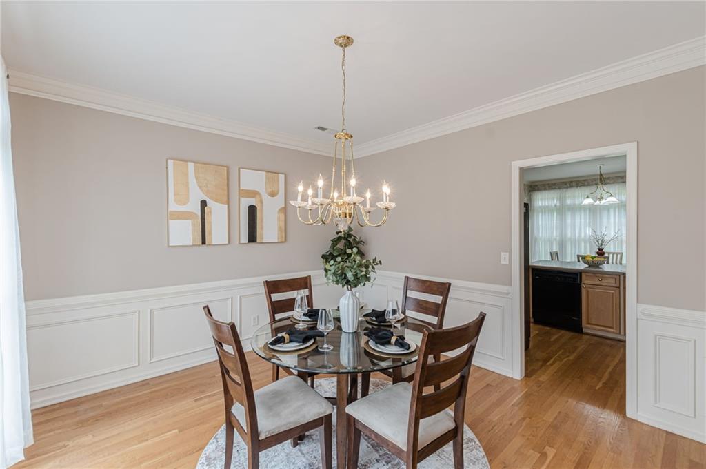700 James Madison Drive South Fulton, GA 30331 - Photo 15 of 57 a dining room with furniture a chandelier and wooden floor