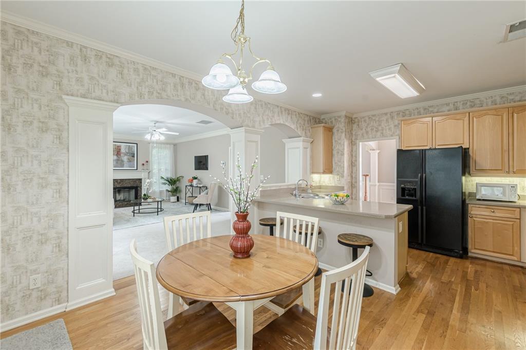 700 James Madison Drive South Fulton, GA 30331 - Photo 22 of 57 a kitchen with stainless steel appliances kitchen island granite countertop a dining table chairs and granite counter tops
