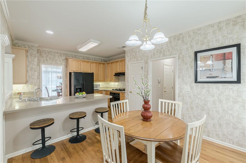 700 James Madison Drive South Fulton, GA 30331 - Photo 23 of 57 a view of a dining room with furniture a chandelier and wooden floor