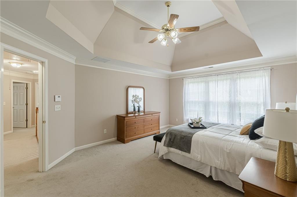 700 James Madison Drive South Fulton, GA 30331 - Photo 52 of 57 a spacious bedroom with a bed a chandelier and a window