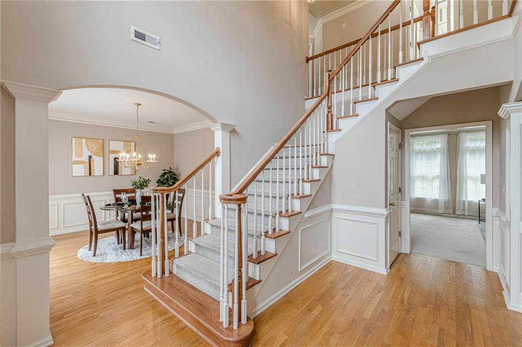700 James Madison Drive South Fulton, GA 30331 - Photo 9 of 57 a view of staircase with dining table and a chandelier