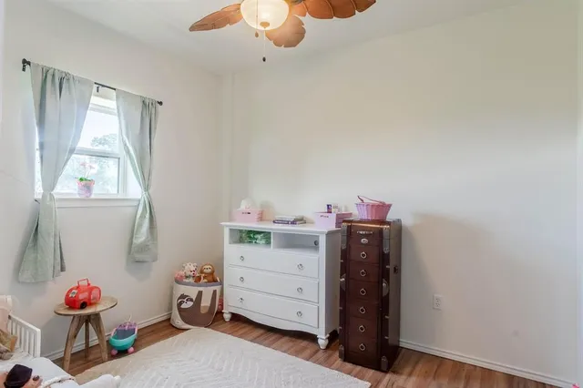 a view of a bedroom with baby crib and furniture