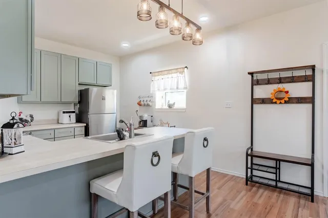 a kitchen with refrigerator and window