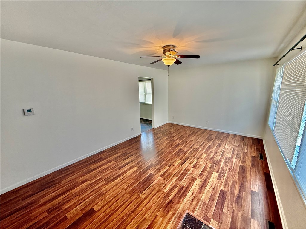 127 Isabella Drive Decatur, IL 62521 - Photo 2 of 16 a view of a room with wooden floor and a ceiling fan