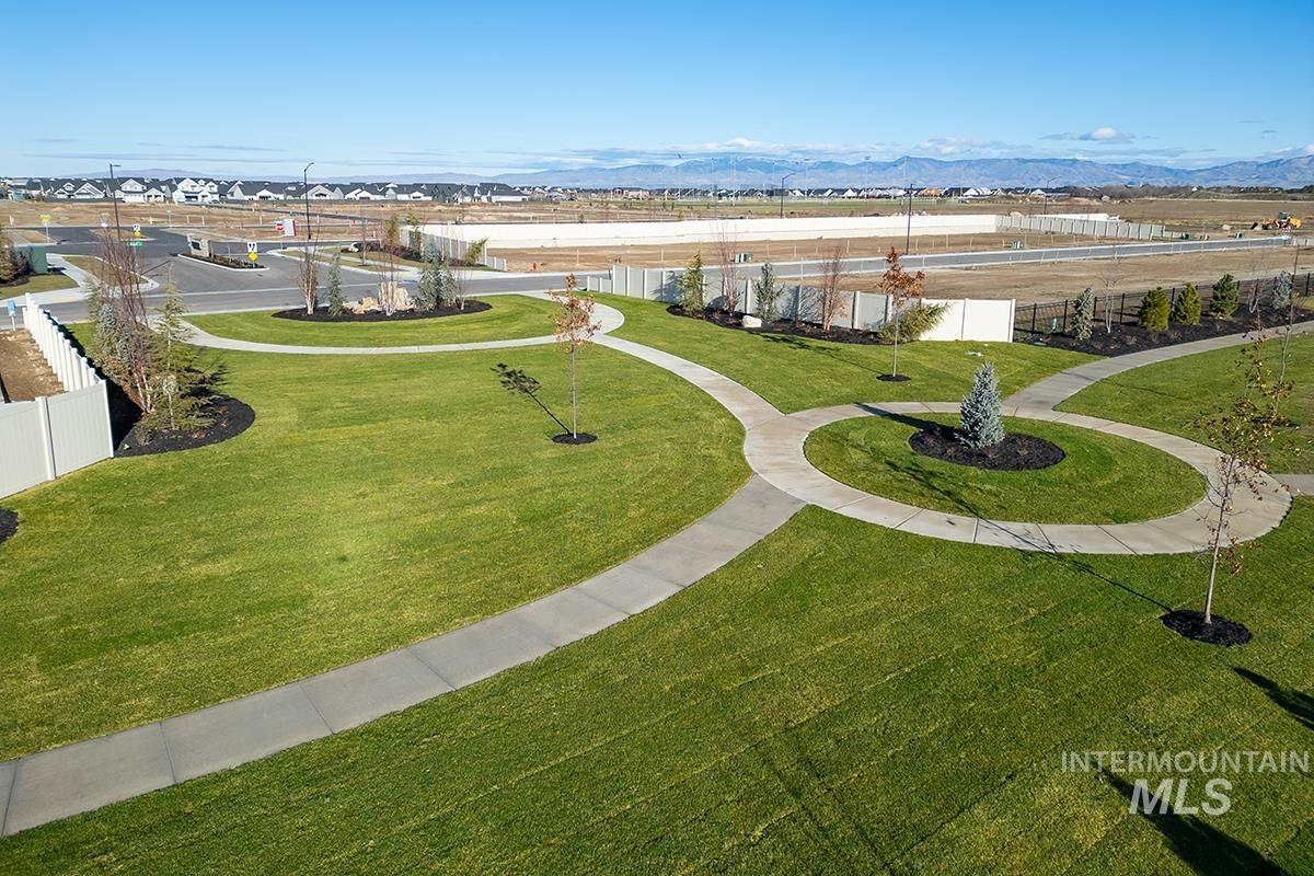 1700 East Hadler Street Meridian, ID 83642 - Photo 21 of 25 Expansive green space featuring curved concrete pathways, manicured lawns, and young trees