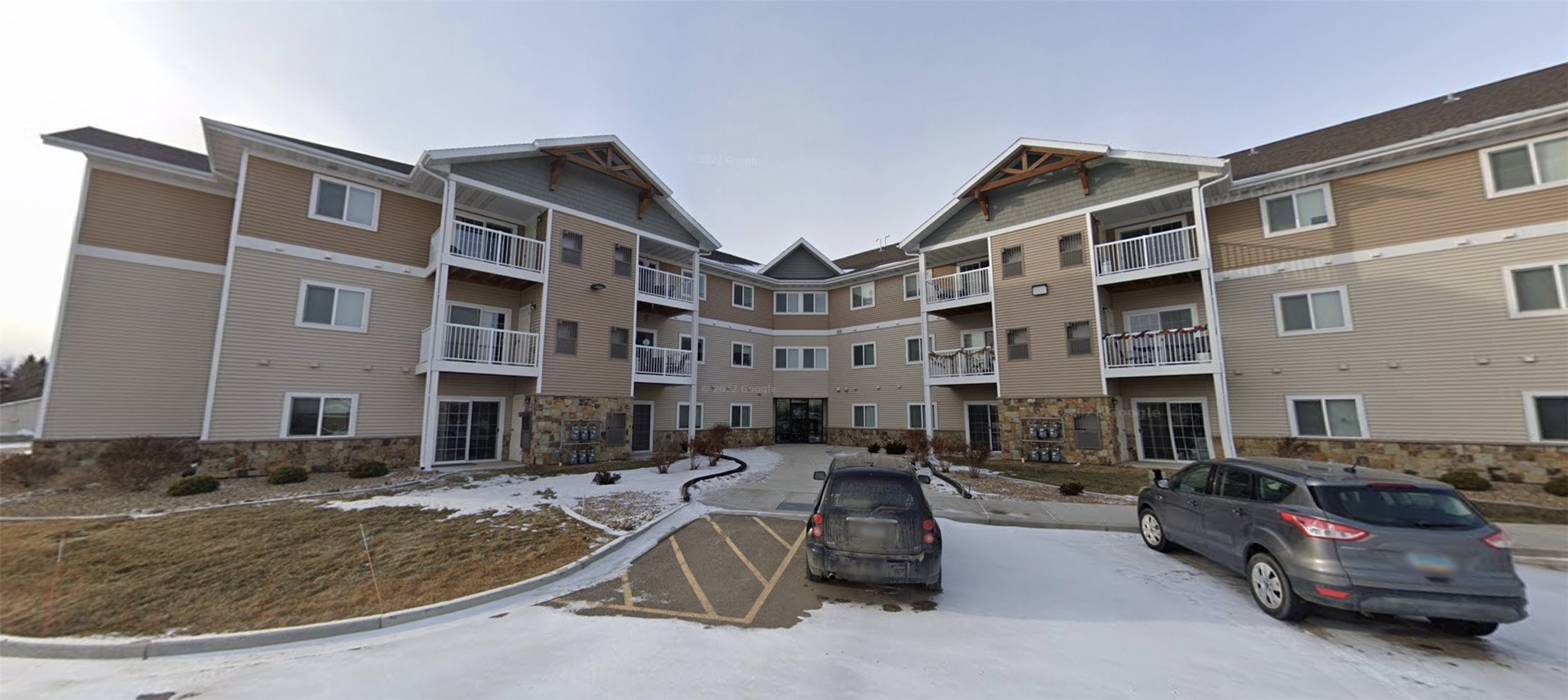 2821 Ithaca Drive Bismarck, ND 58503 - Photo 3 of 8 a car parked in front of a brick building