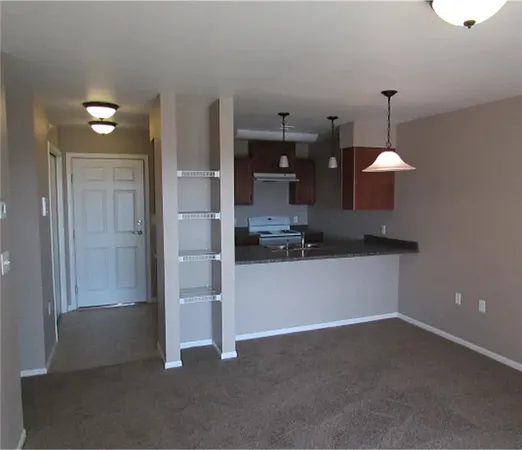 a view of a kitchen with a refrigerator stove and cabinets