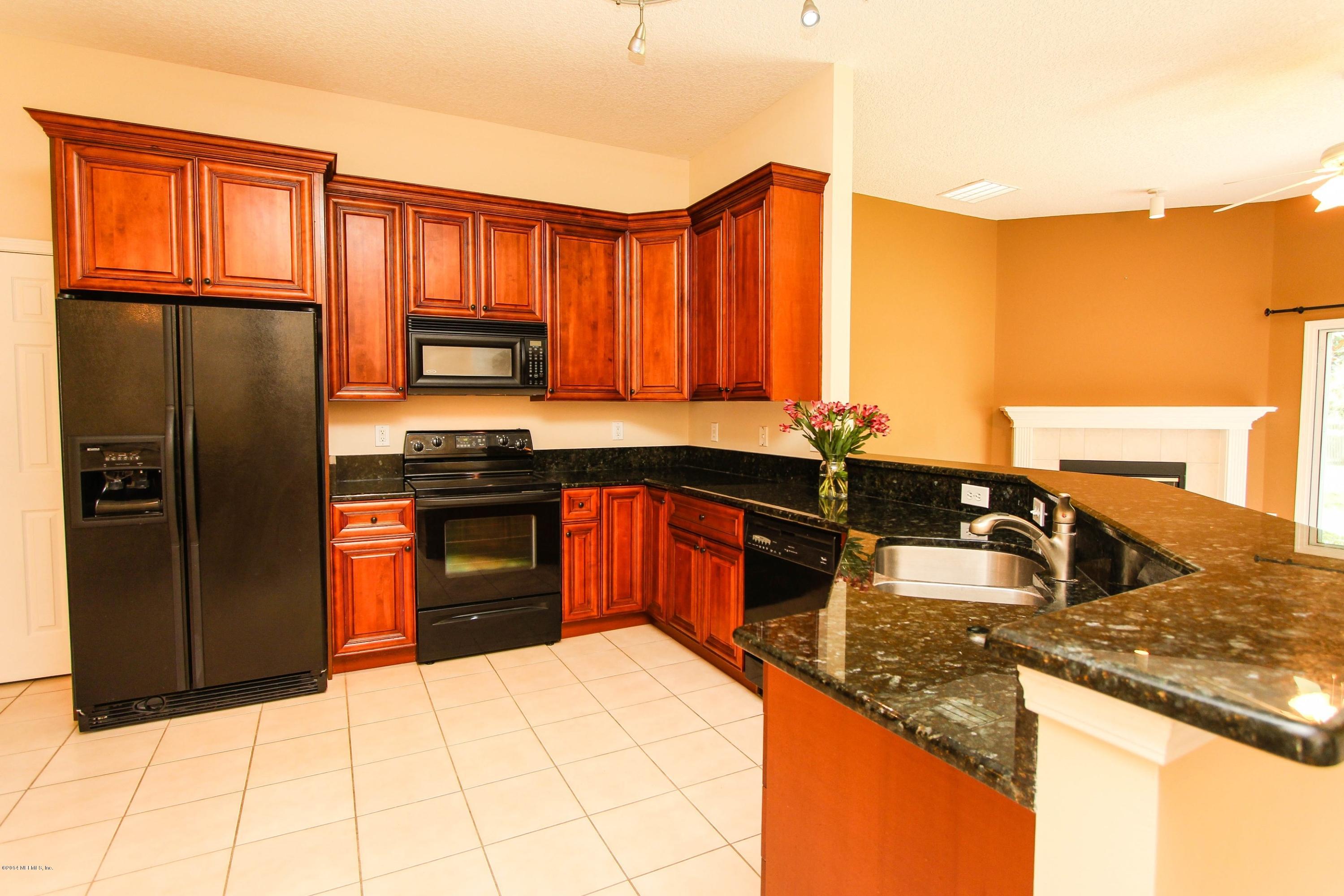 1252 Ribbon Road St. Johns, FL 32259 - Photo 11 of 27 a kitchen with stainless steel appliances granite countertop a stove a sink dishwasher and a refrigerator