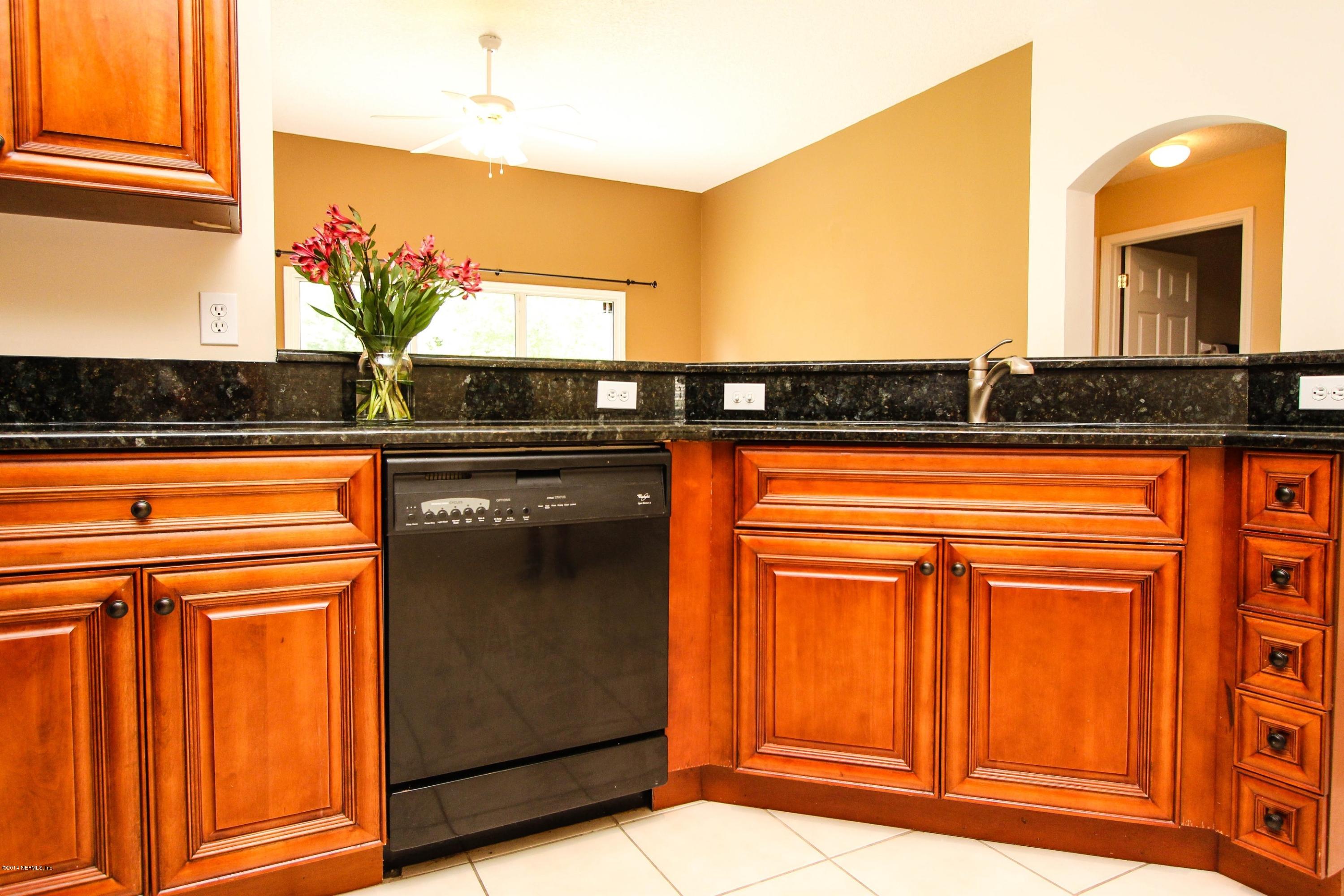 1252 Ribbon Road St. Johns, FL 32259 - Photo 13 of 27 a view of a kitchen with wooden floor and a large window