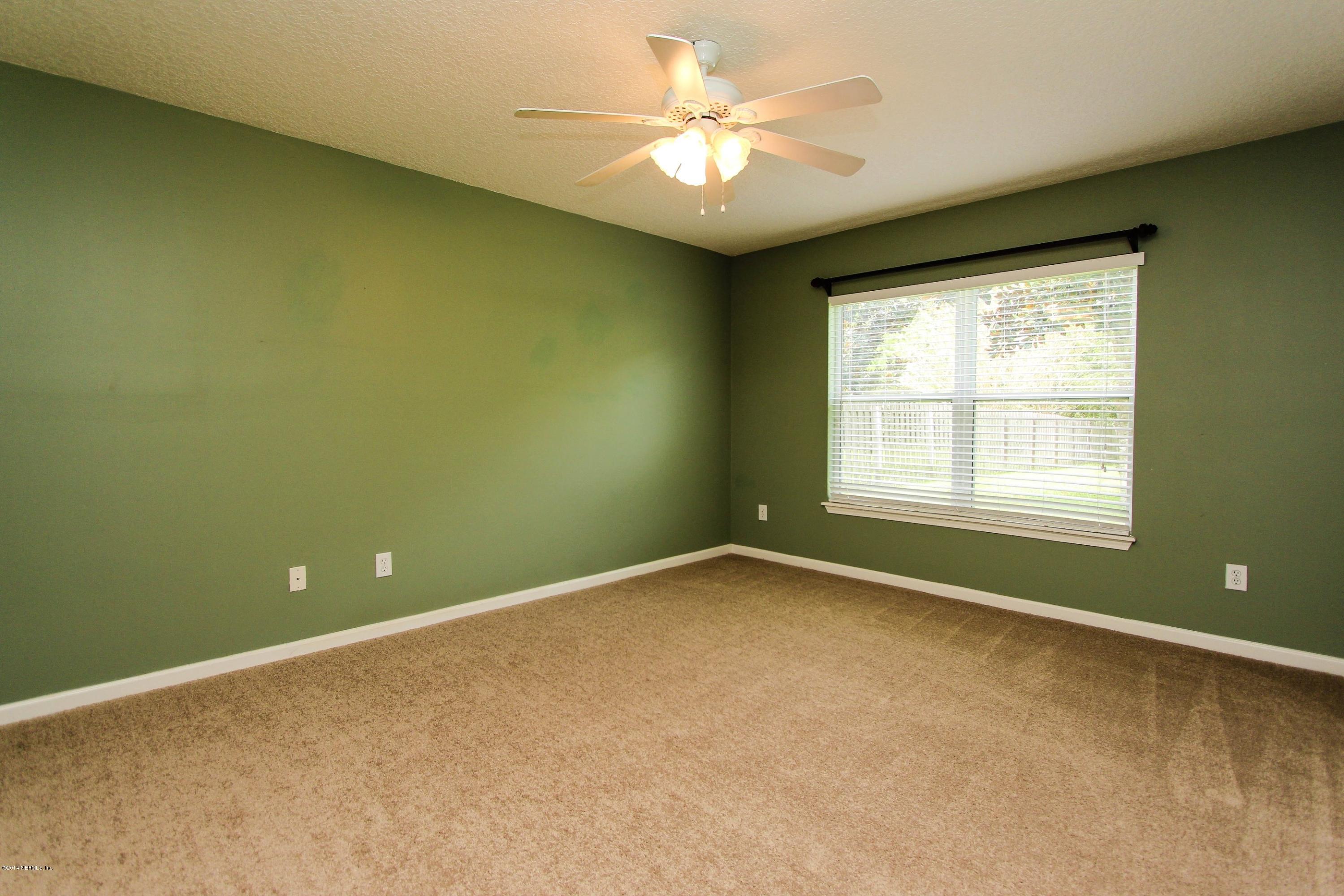 1252 Ribbon Road St. Johns, FL 32259 - Photo 16 of 27 an empty room with a window and a ceiling fan