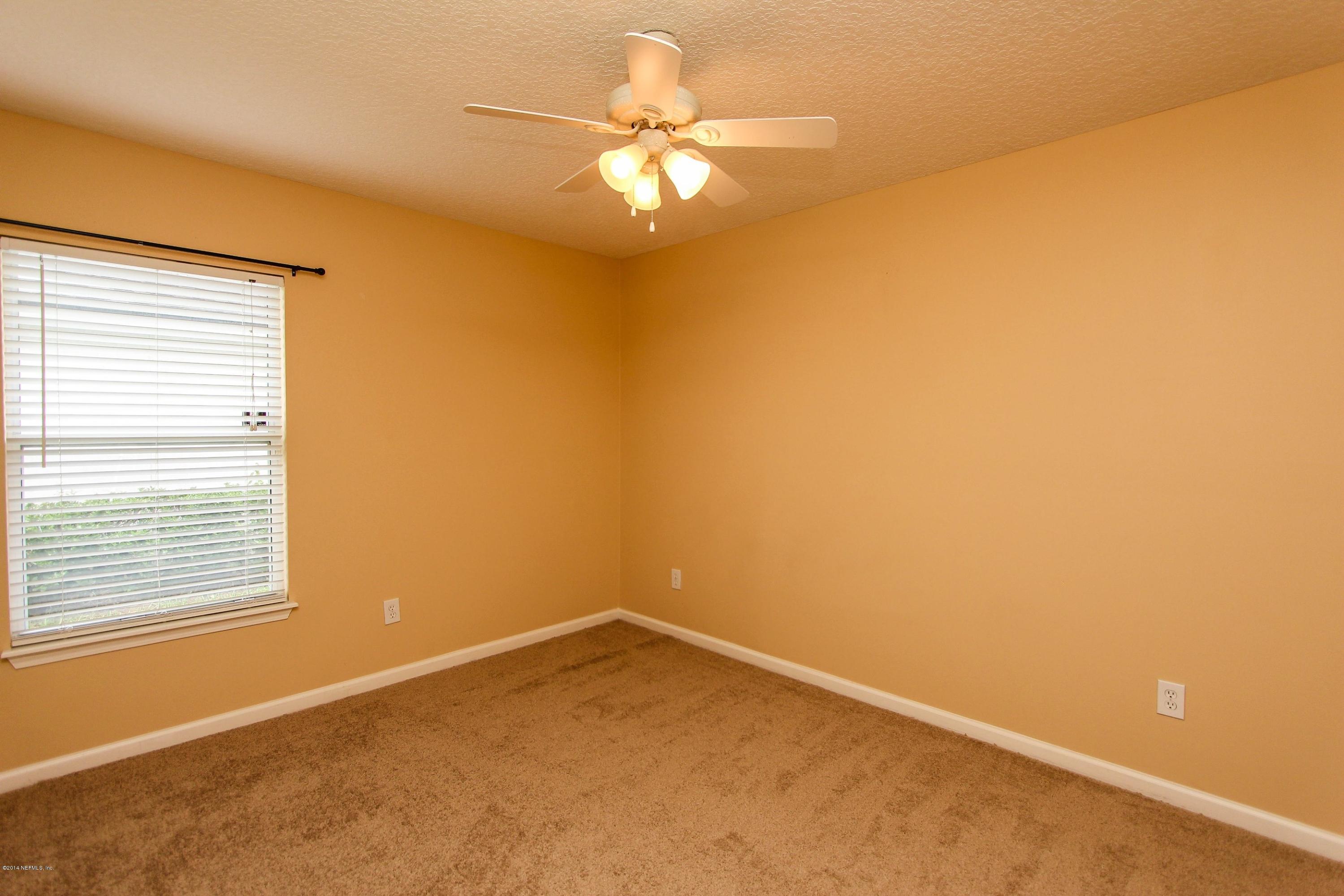 1252 Ribbon Road St. Johns, FL 32259 - Photo 18 of 27 an empty room with a window and a ceiling fan