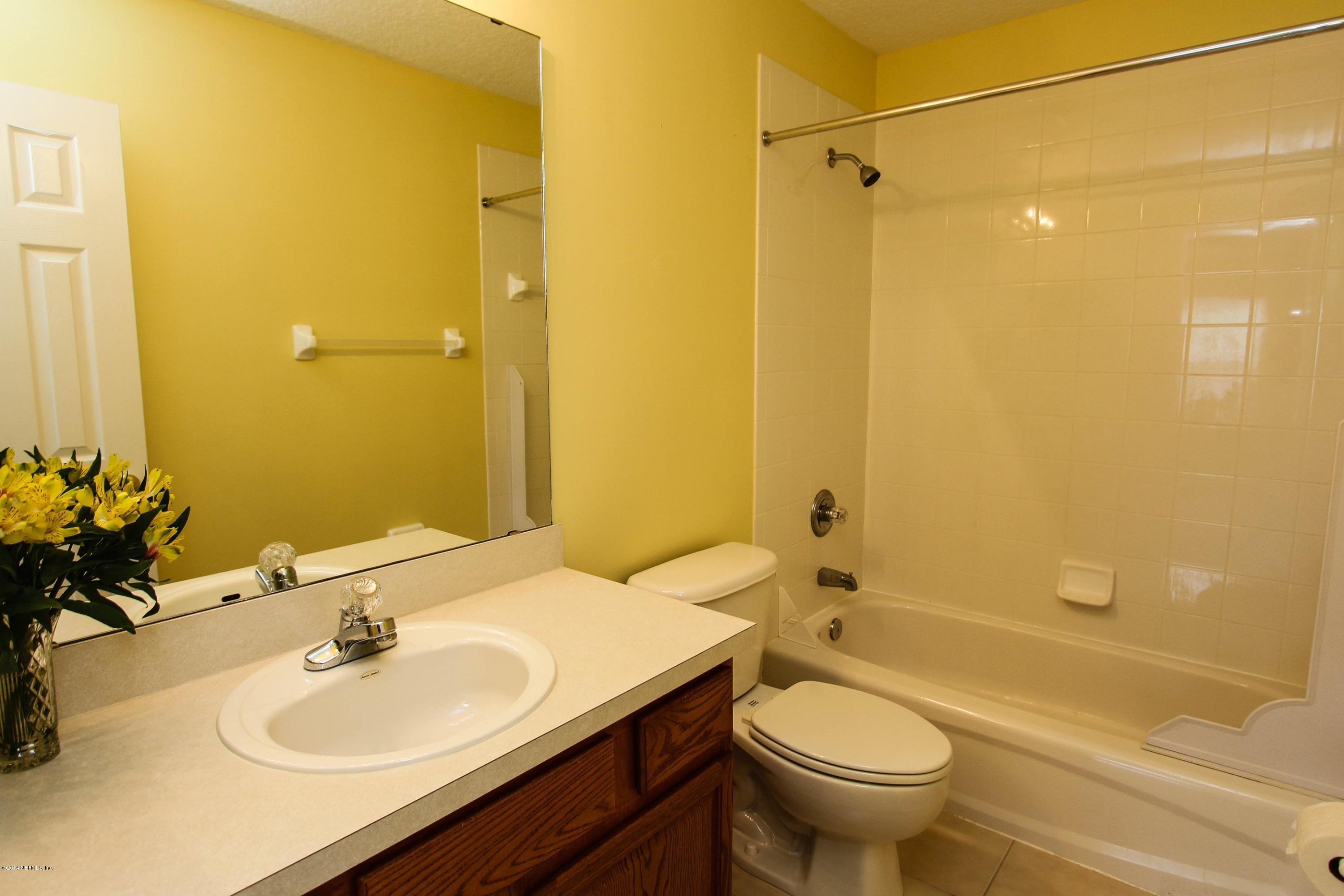 1252 Ribbon Road St. Johns, FL 32259 - Photo 22 of 27 a bathroom with a sink a toilet and shower