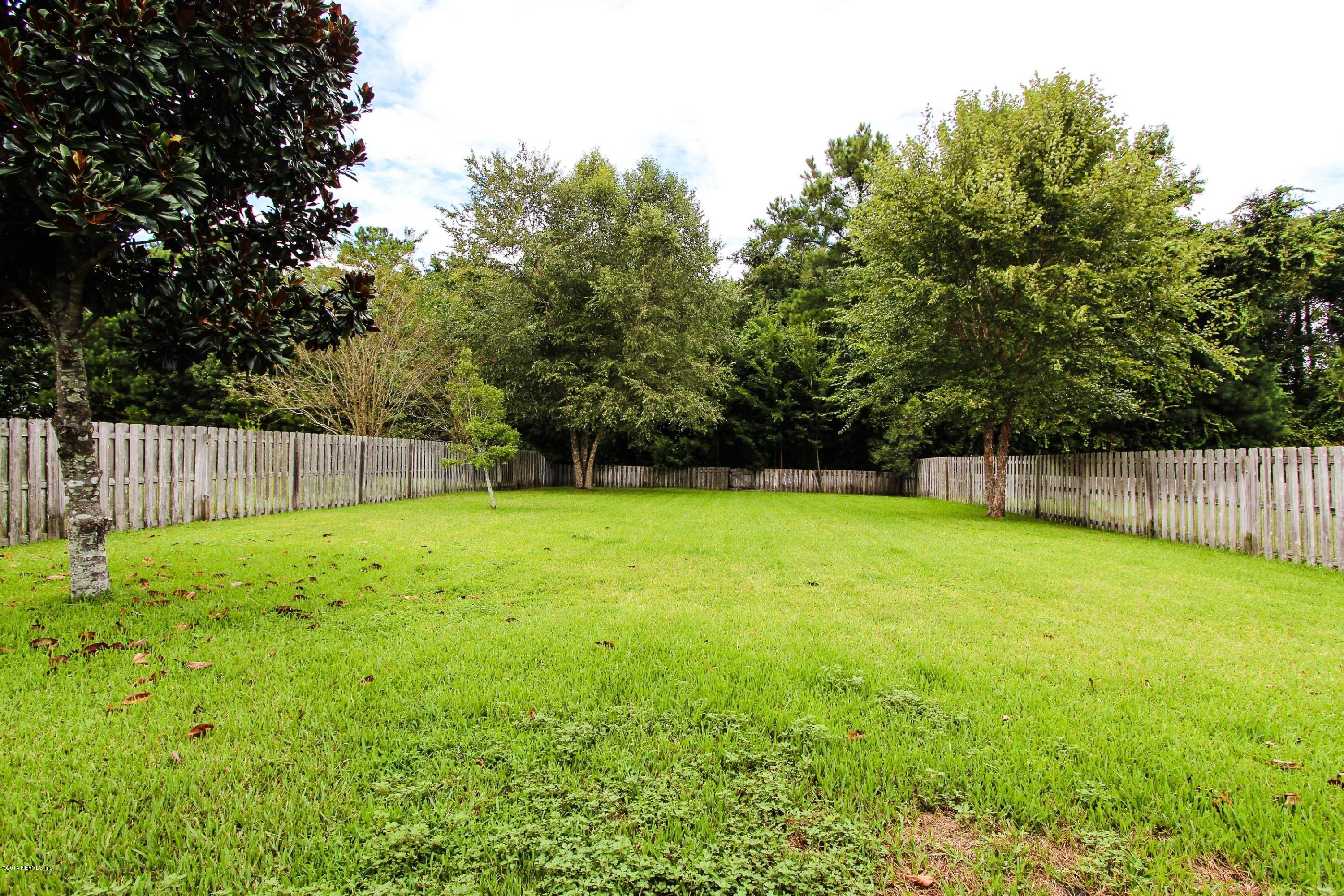 1252 Ribbon Road St. Johns, FL 32259 - Photo 27 of 27 a view of a backyard with a garden and trees