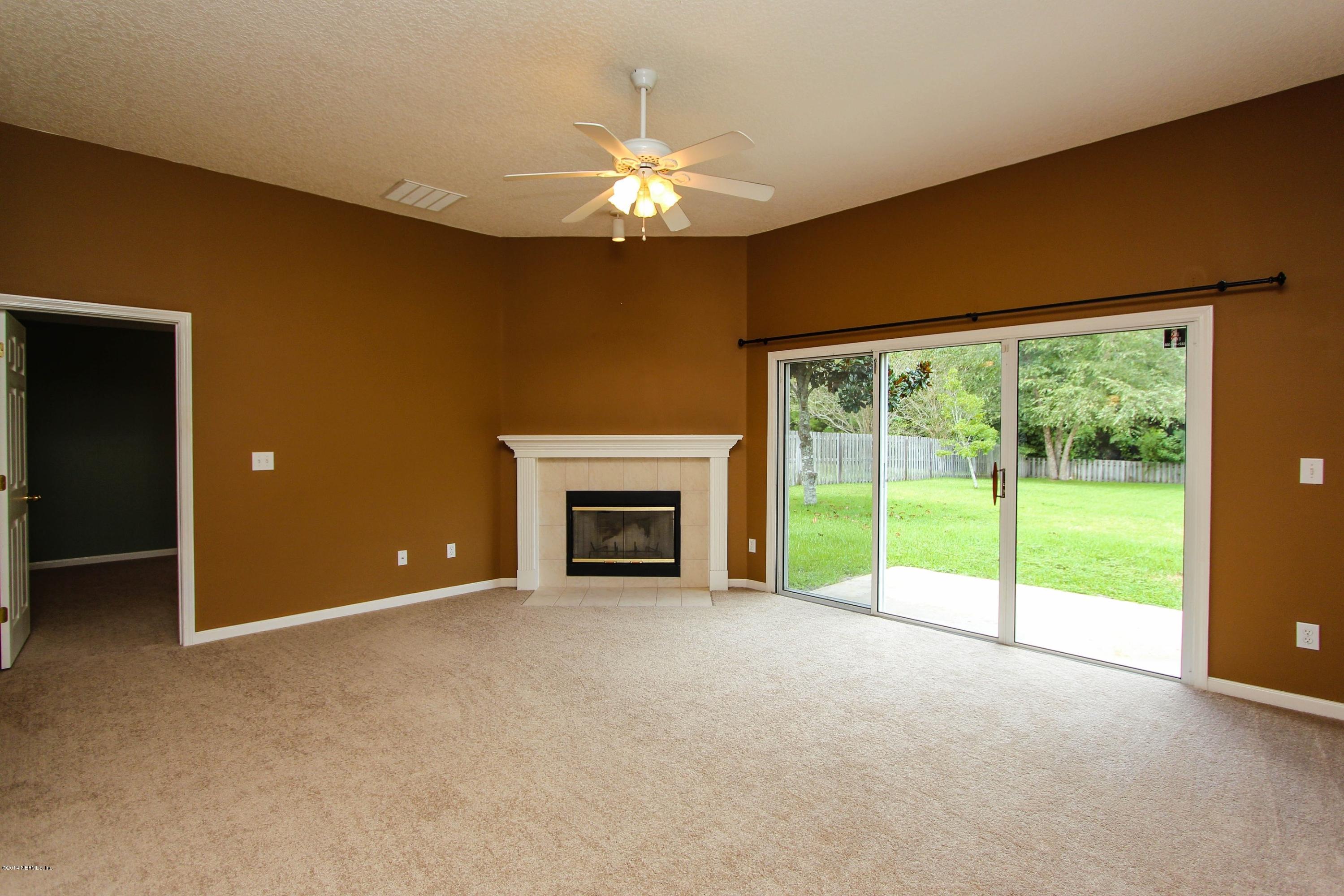 1252 Ribbon Road St. Johns, FL 32259 - Photo 8 of 27 a view of an empty room with a fireplace and a large window