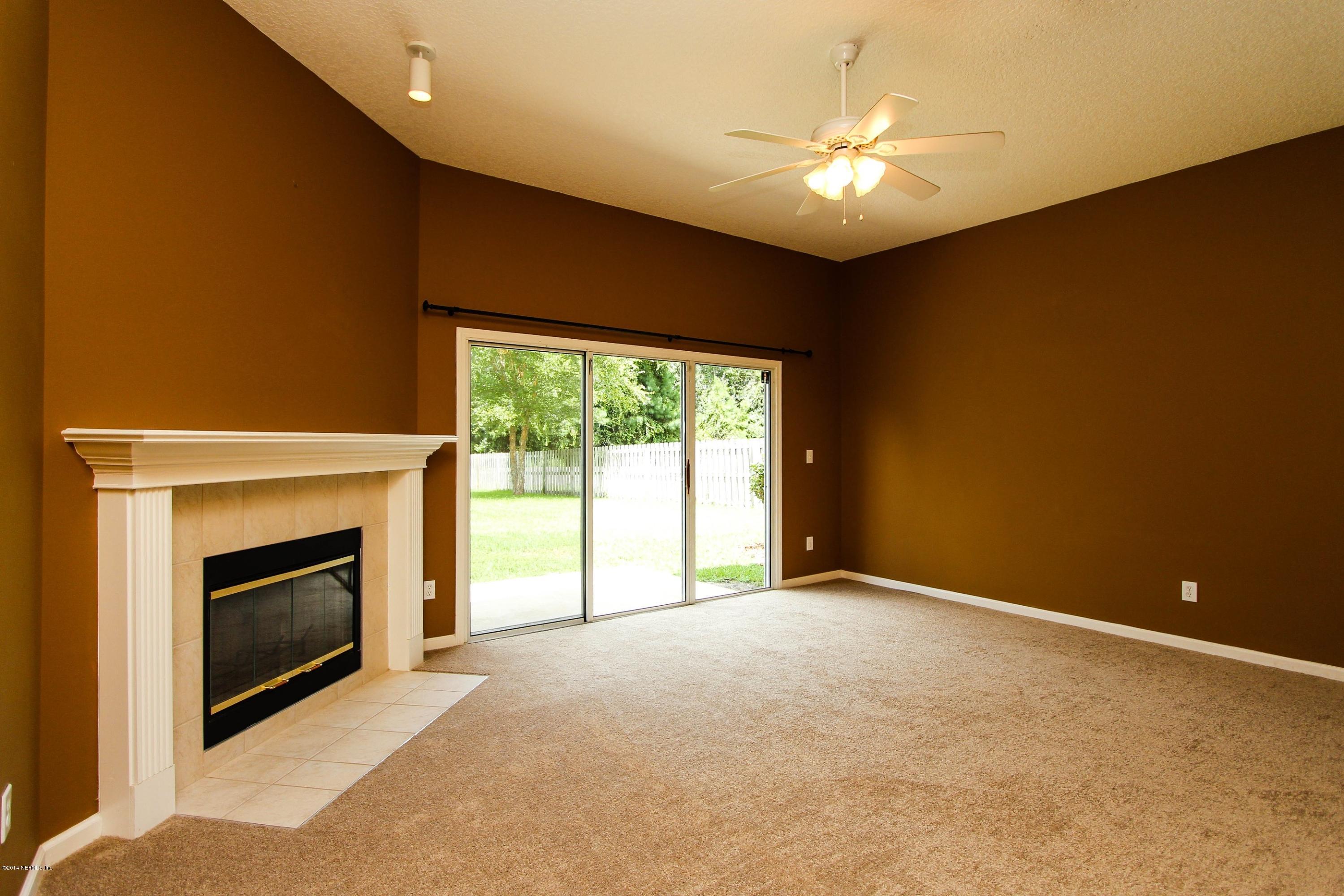 1252 Ribbon Road St. Johns, FL 32259 - Photo 9 of 27 a view of an empty room with a fireplace and a window