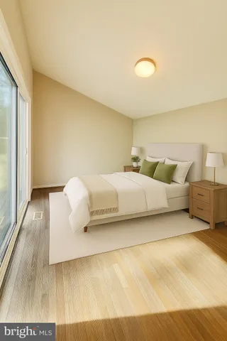 a bedroom with a bed and a night stand