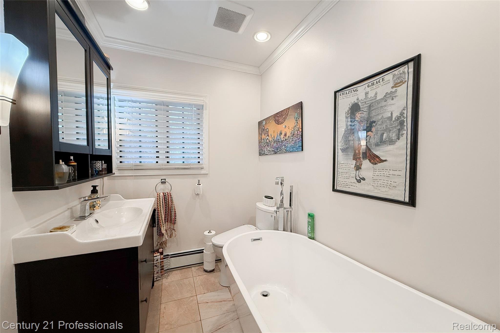 910 West Pine Tree Road West Lake Orion, MI 48362 - Photo 25 of 52 Bathroom featuring vanity, a soaking tub, ornamental molding, a baseboard radiator, and recessed lighting