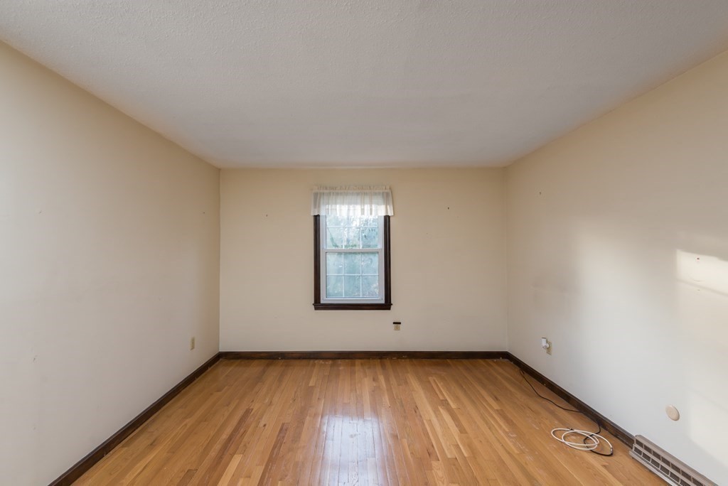 26 Carver Road Plymouth, MA 02360 - Photo 13 of 25 an empty room with wooden floor and windows