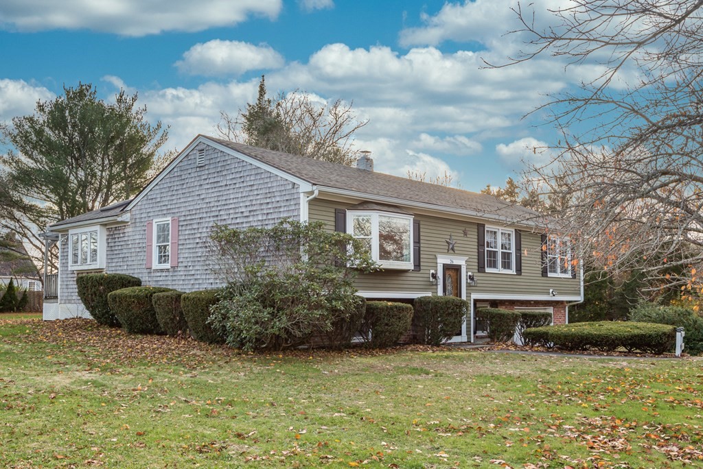 26 Carver Road Plymouth, MA 02360 - Photo 3 of 25 a front view of a house with a garden and plants