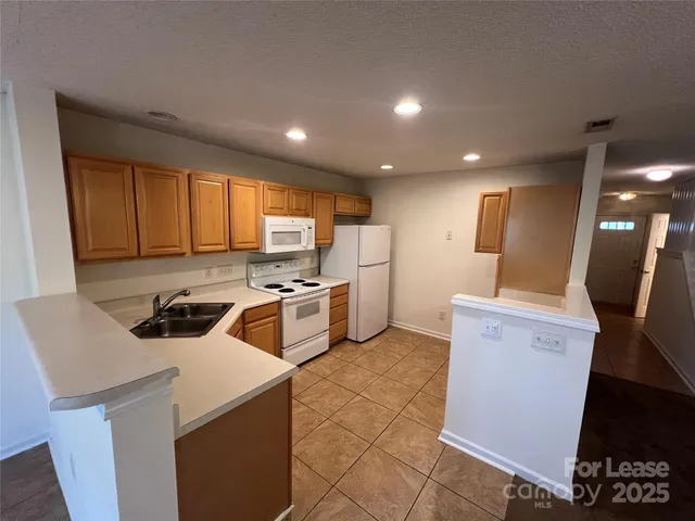 a kitchen that has a sink a stove top oven a counter space and cabinets