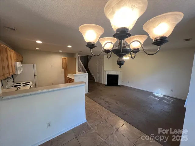 a view of kitchen and kitchen island with wooden floor