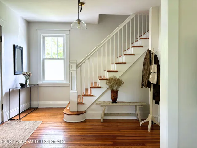 a view of entryway and hall with wooden floor
