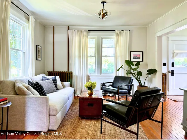 a dining room with furniture a chandelier and wooden floor