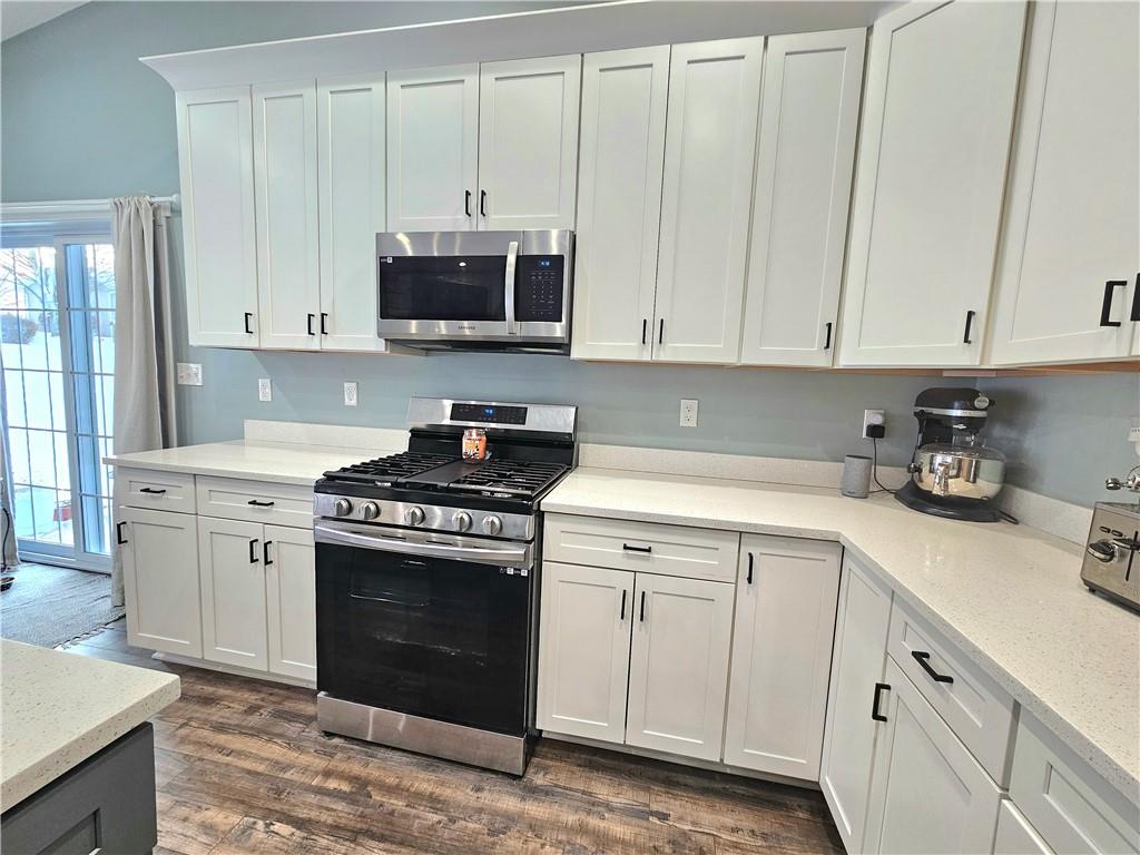 300 7th Avenue New Eagle, PA 15067 - Photo 7 of 22 a kitchen with granite countertop white cabinets and stainless steel appliances