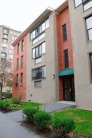 a front view of a building with a yard