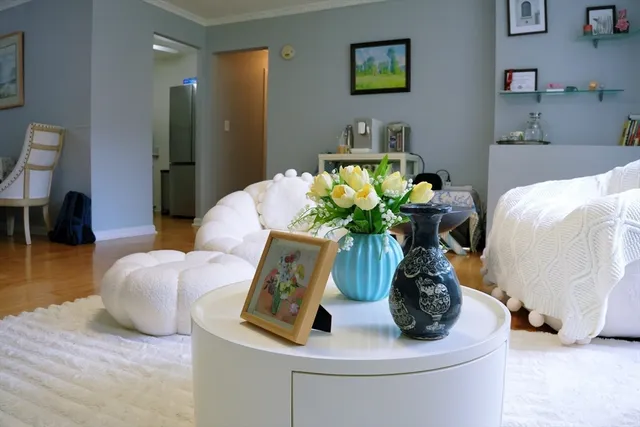 a white vase with flowers