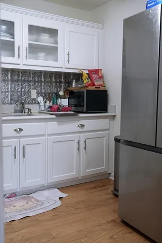 a kitchen with white cabinets and white appliances