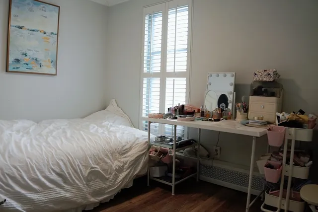 a bedroom with a bed and a desk