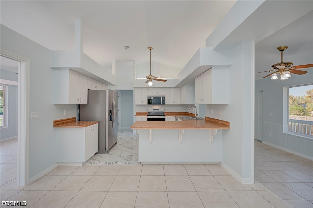 16380 Arbor Ridge Drive Fort Myers, FL 33908 - Photo 12 of 47 a large kitchen with stainless steel appliances a stove a sink dishwasher and a refrigerator