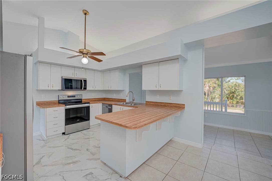 16380 Arbor Ridge Drive Fort Myers, FL 33908 - Photo 15 of 47 a kitchen with stainless steel appliances granite countertop a sink a stove top oven a counter space and cabinets