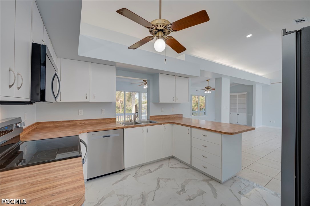 16380 Arbor Ridge Drive Fort Myers, FL 33908 - Photo 16 of 47 a large white kitchen with a sink and cabinets