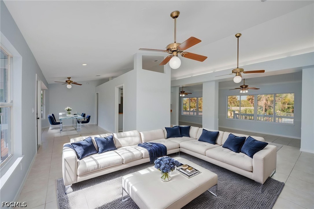 16380 Arbor Ridge Drive Fort Myers, FL 33908 - Photo 2 of 47 a living room with furniture and a chandelier