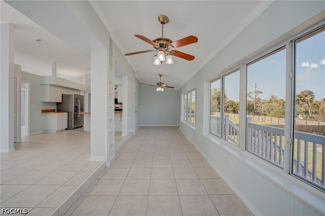 16380 Arbor Ridge Drive Fort Myers, FL 33908 - Photo 21 of 47 a view of a hallway with a chandelier fan and windows