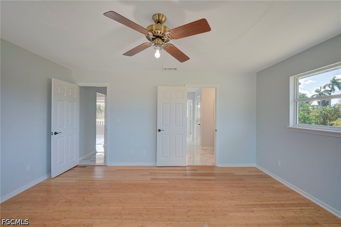 16380 Arbor Ridge Drive Fort Myers, FL 33908 - Photo 27 of 47 a view of an empty room with window and wooden floor