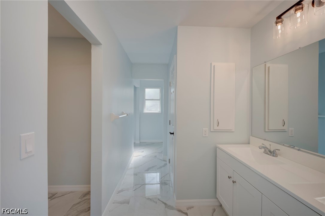 16380 Arbor Ridge Drive Fort Myers, FL 33908 - Photo 28 of 47 a bathroom with a sink and a mirror