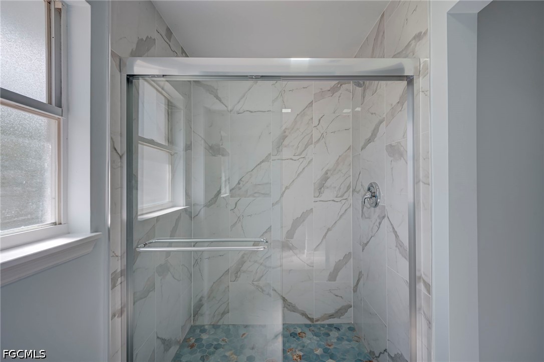 16380 Arbor Ridge Drive Fort Myers, FL 33908 - Photo 30 of 47 a bathroom with a glass shower door