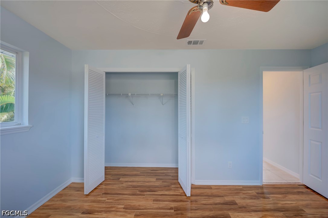 16380 Arbor Ridge Drive Fort Myers, FL 33908 - Photo 37 of 47 a view of an empty room with wooden floor and a window