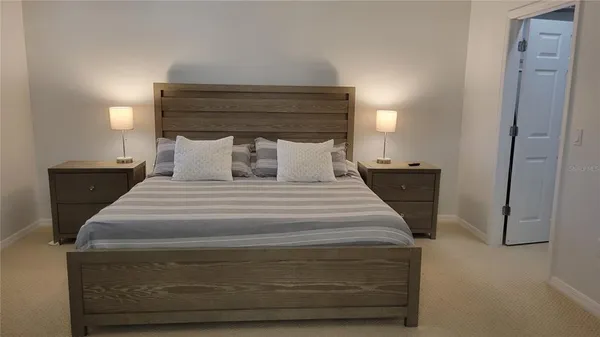 a bedroom with a bed and a night stand
